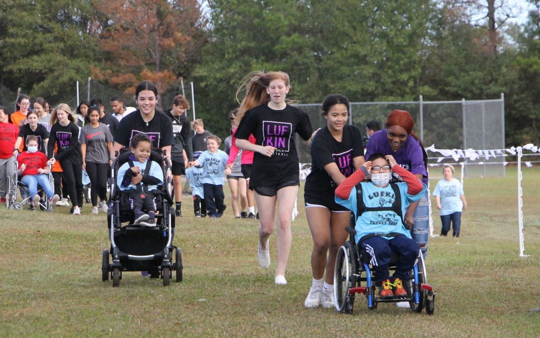 Annual Turkey Trot partners high school athletes with special needs children for a fun morning